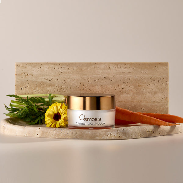 Osmosis Carrot Calendula skincare product on a stone surface with a natural background
