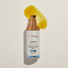 Osmosis Clarify serum bottle with a yellow product smear on a beige background