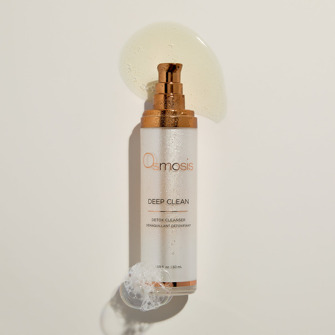 Osmosis Deep Clean detox cleanser bottle on a light background with bubbles