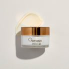 Osmosis skincare jar with cream product smeared on a white background