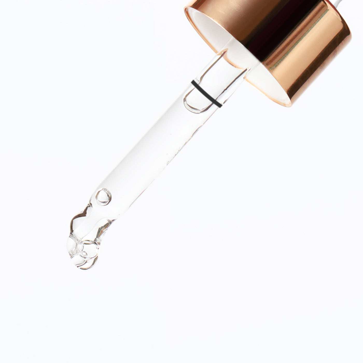 Clear glass bottle with a gold cap on a white background