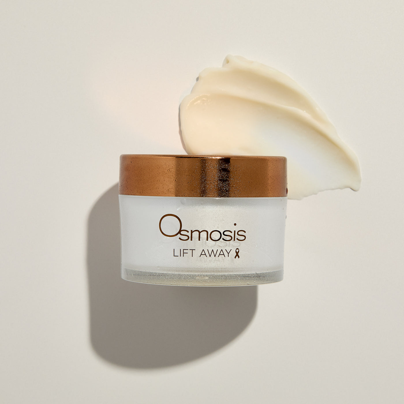 Osmosis Lift Away skincare product with a gold lid on a light background