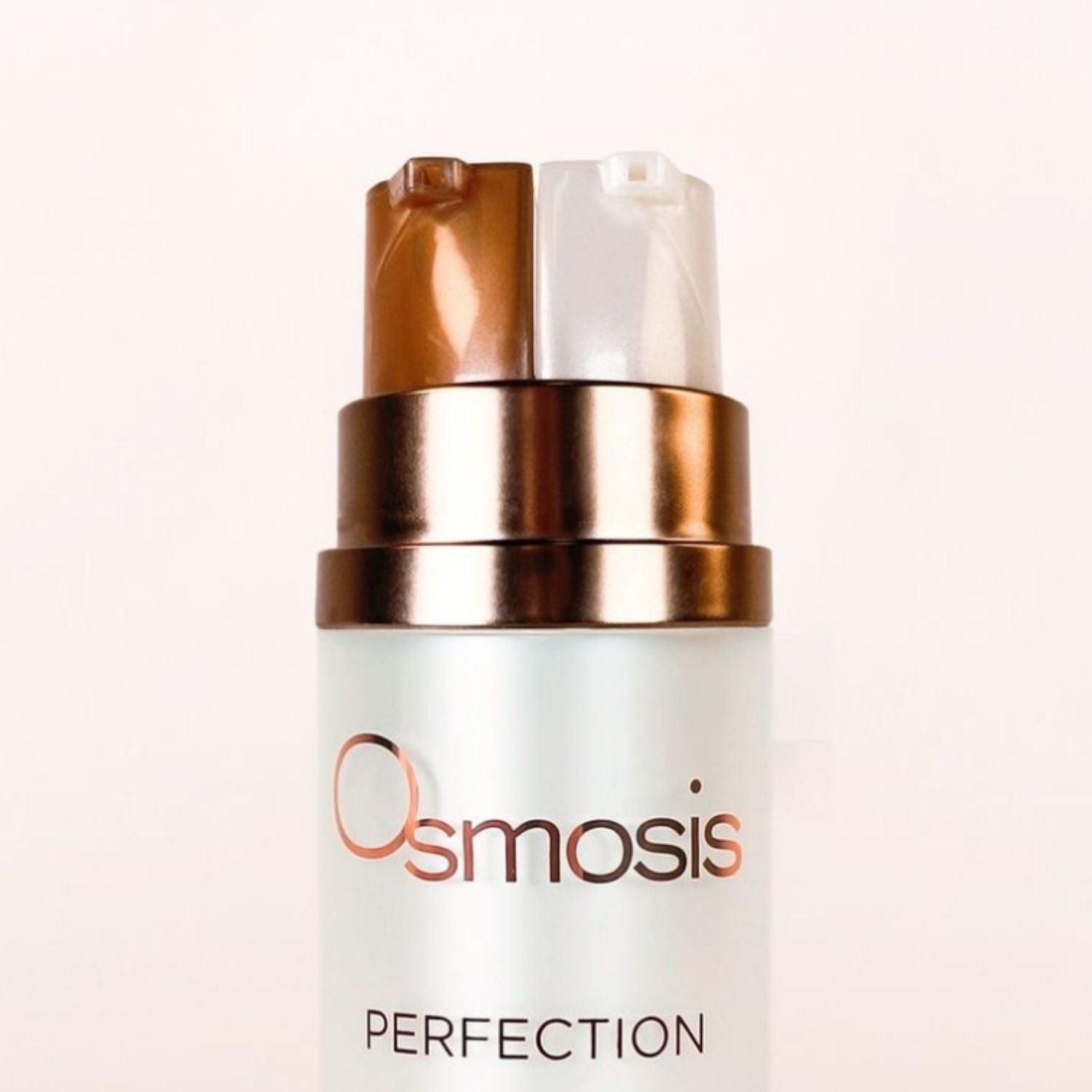 Close-up of Osmosis perfection dual pumps on the top of the bottle displayed on a white background
