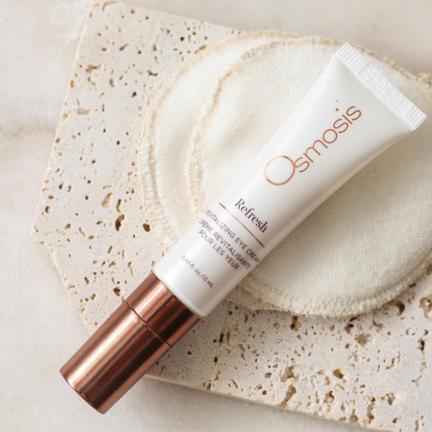 Osmosis Refresh eye cream product on a textured surface