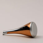 Osmosis cool skin tool lying on its side with a light grey background