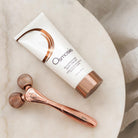 epic body tool displayed next to Rejuvenating body cream on white table