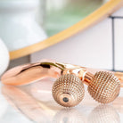 side view of rose gold epic skin tool displayed on marble counter