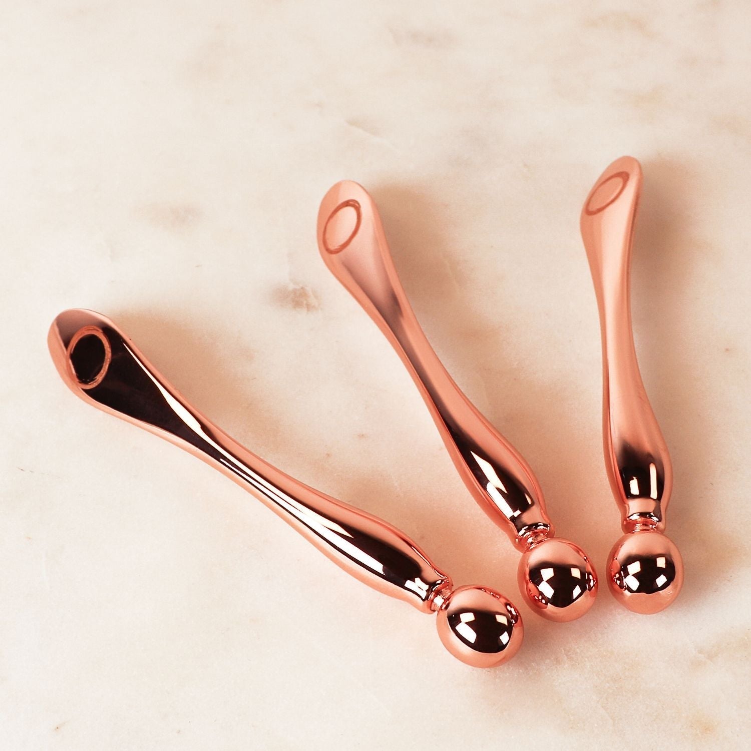 Three mini multi tool displayed on beige background