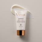 Osmosis Quench moisturizer tube on a beige background