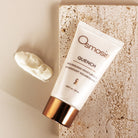 Osmosis Quench nourishing moisturizer on a textured beige surface