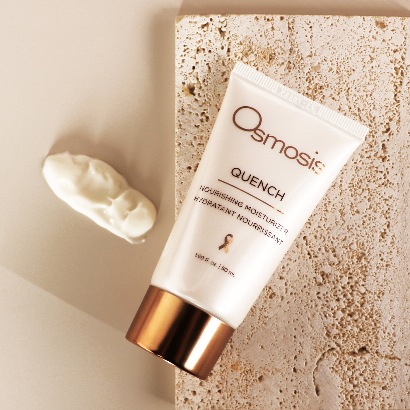 Osmosis Quench nourishing moisturizer on a textured beige surface