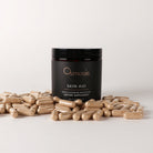 Osmosis Skin Aid supplement jar with capsules on a light gray background