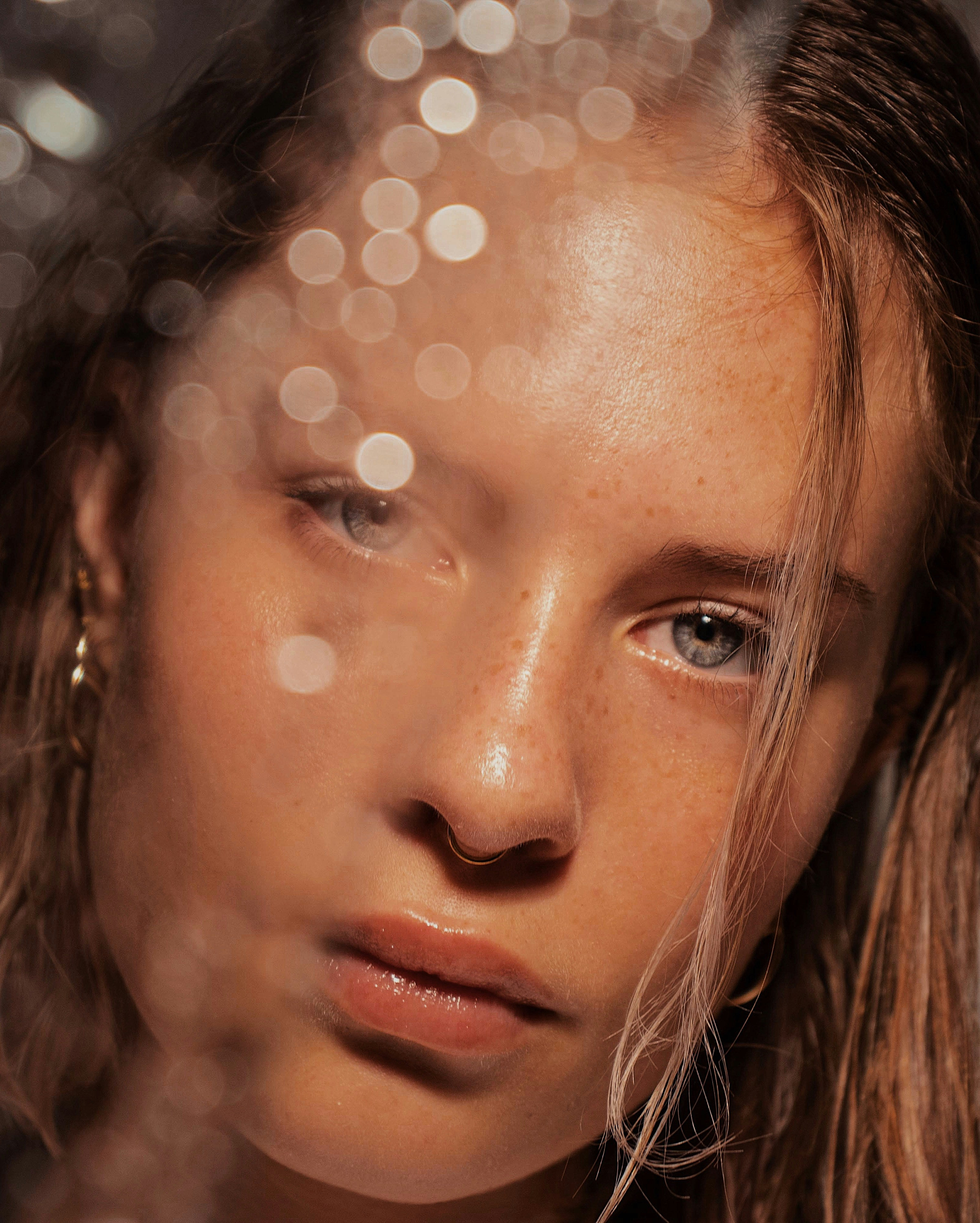 Close-up of a person with water droplets in front of their face