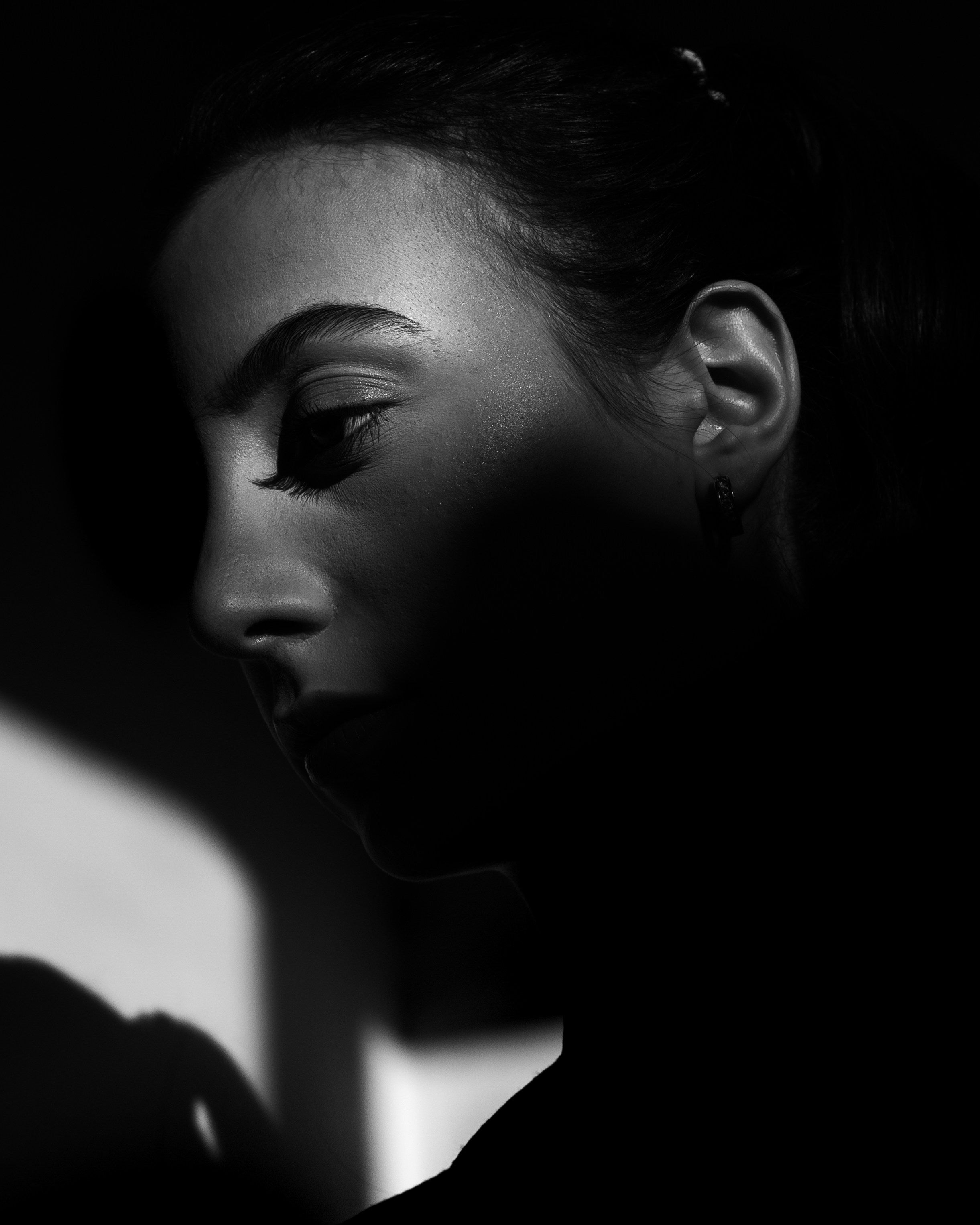 Black and white portrait of a woman with dramatic lighting