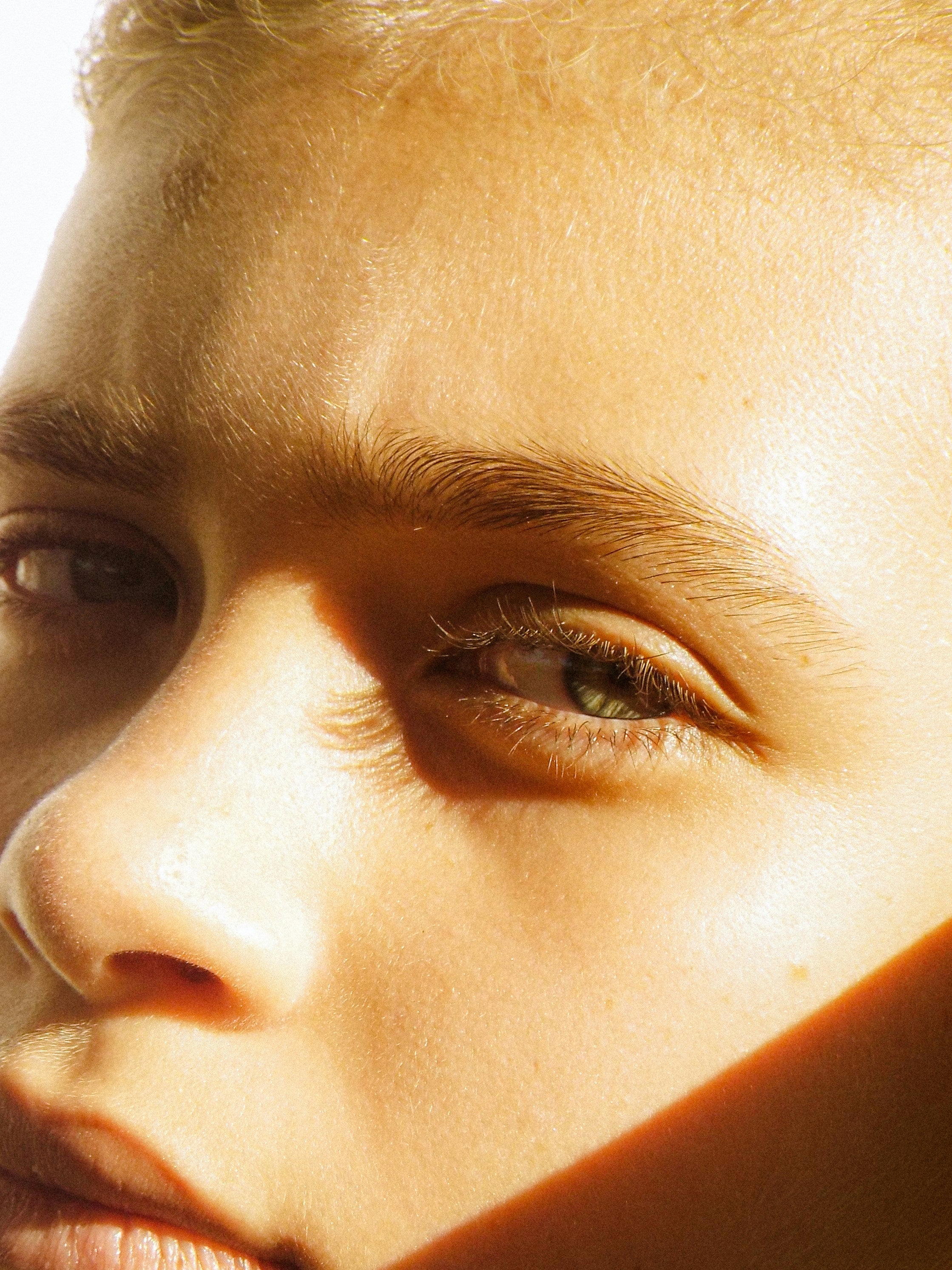 Close-up of a mans eye with a warm, golden light.